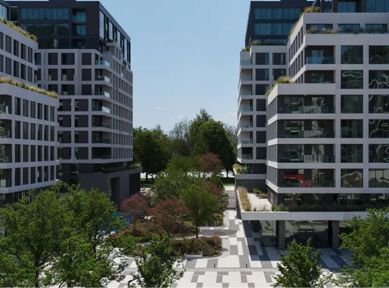 Vue d'un city centre avec ses buildings modernes et contemporains, des espaces verts et un espace piéton.
