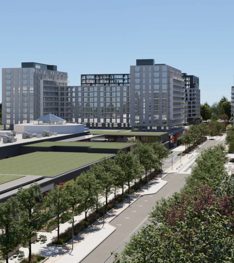 Vue d'un city centre avec des espaces verts à l'avant-plan.