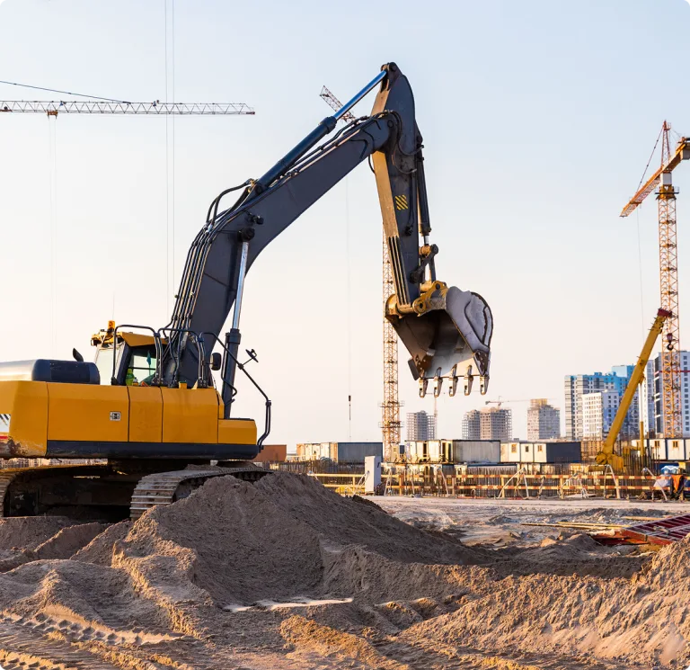 Crane digging at a construction site during the day
